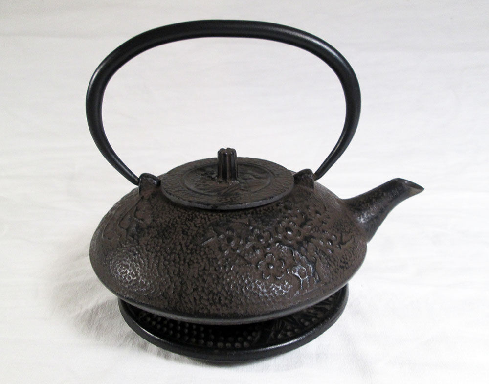 Antique cast iron teapot decorated