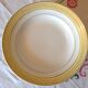 Six white hollow plates on board yellow Monaco 60
