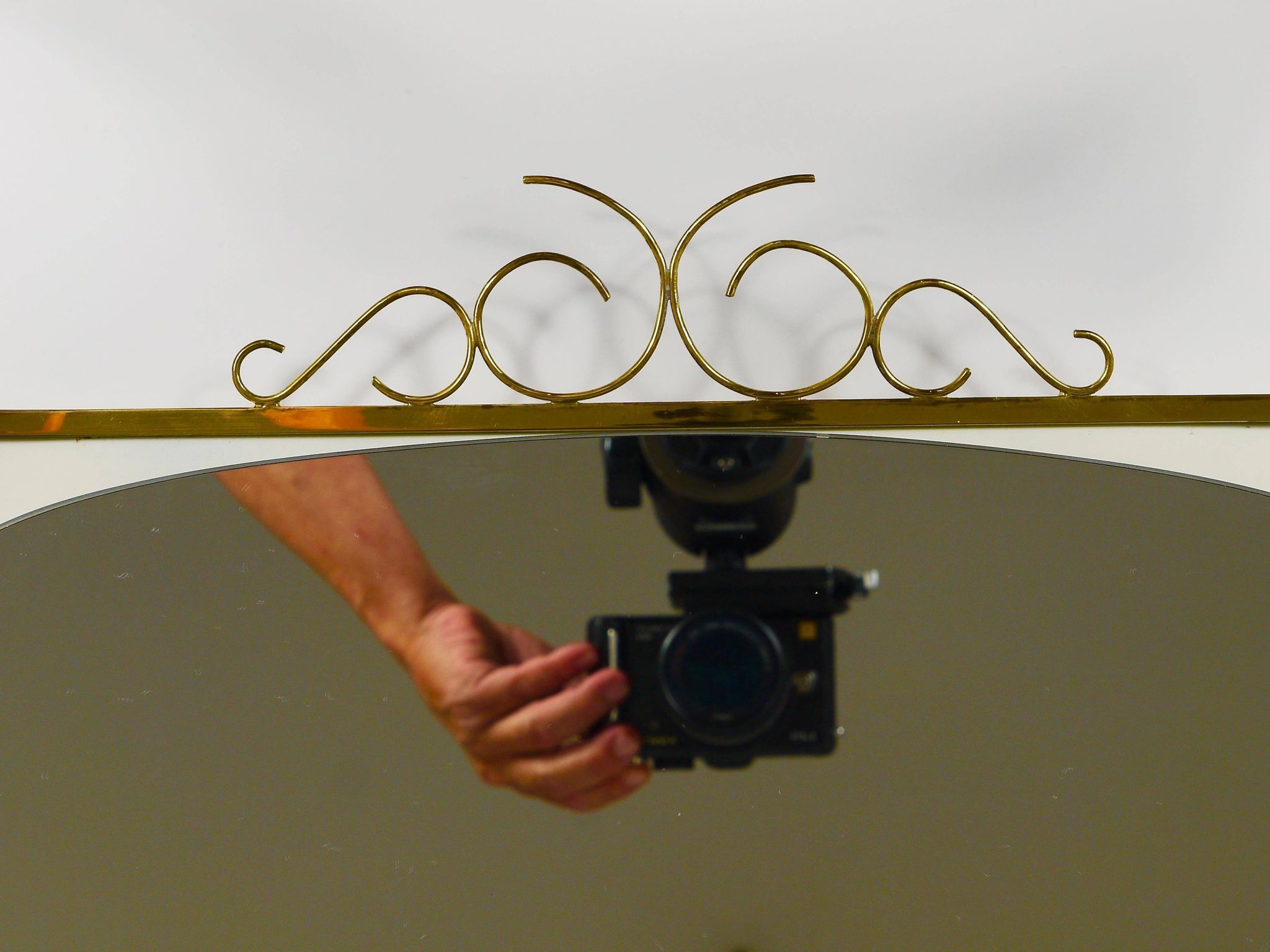 Mid-century illuminated wall mirror by Ernest Igl with brass crown, by Hillebrand.