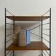 small vintage metal and teak string bookshelf