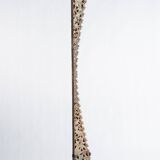 Indonesian construction element in carved wood with intertwined plant motifs mounted on a base (fri