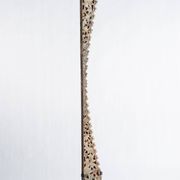 Indonesian construction element in carved wood with intertwined plant motifs mounted on a base (fri