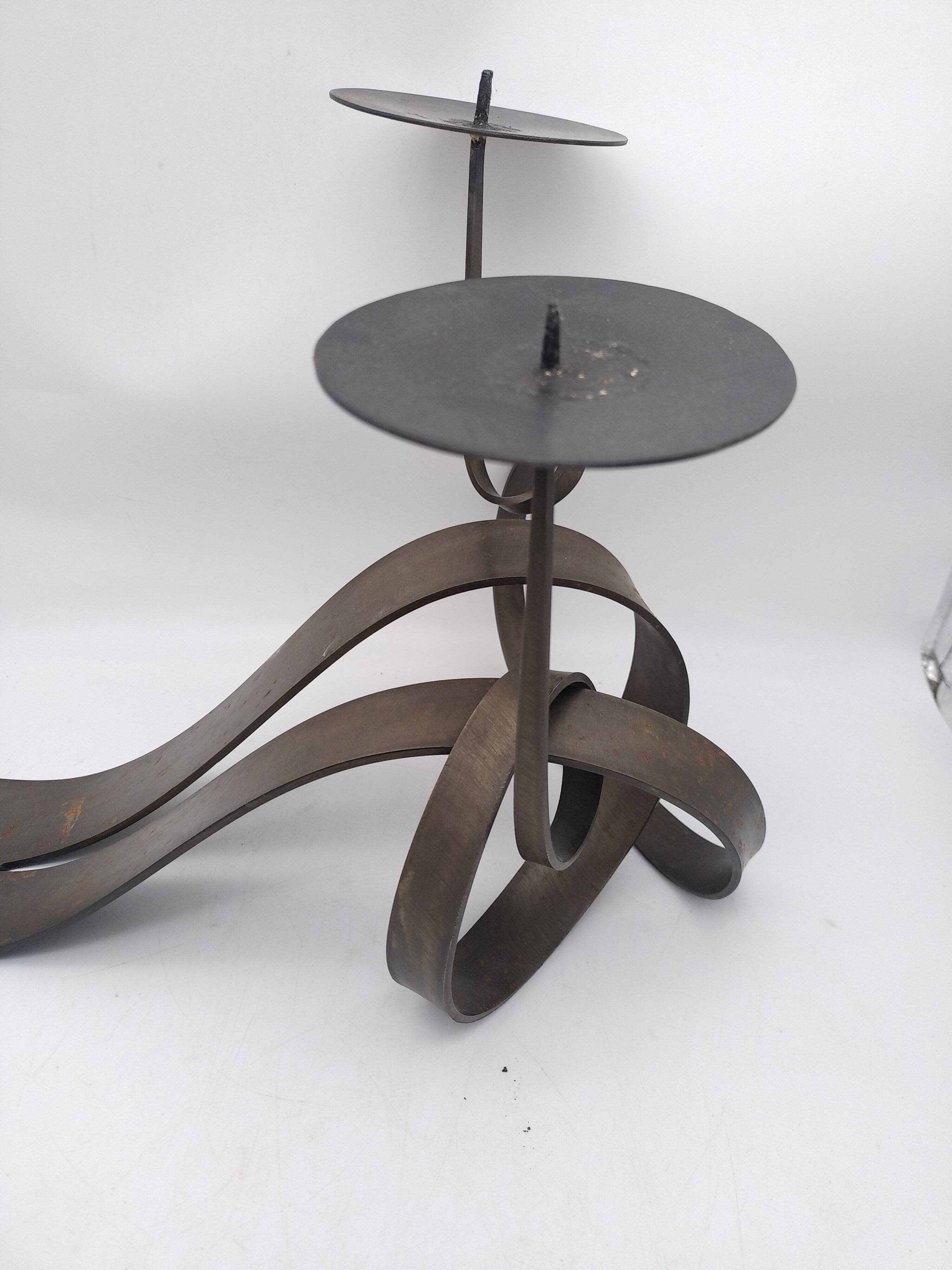 Brutalist candle holder in bronze effect metal.