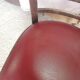 Set of 19 vintage wooden bistro chairs with red faux leather.