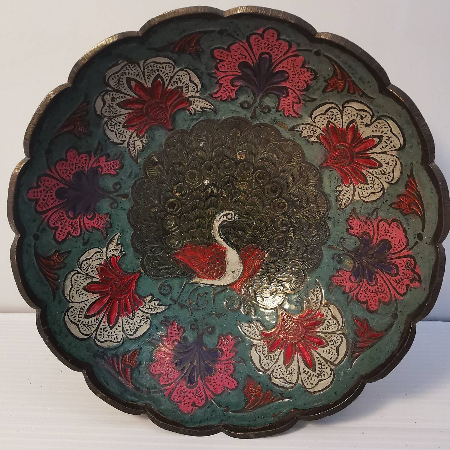 Old Indian brass bowl with peacock decoration