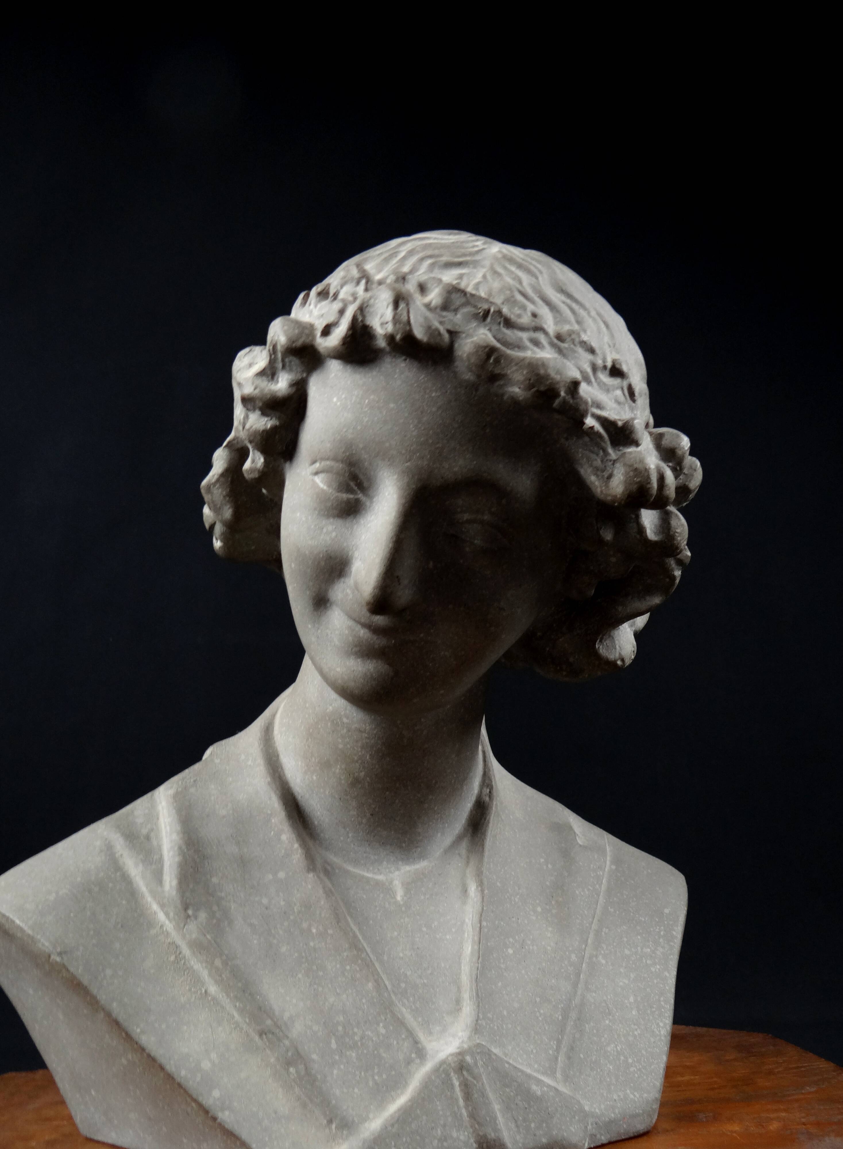Terracotta bust of the smiling angel from Reims Cathedral with base