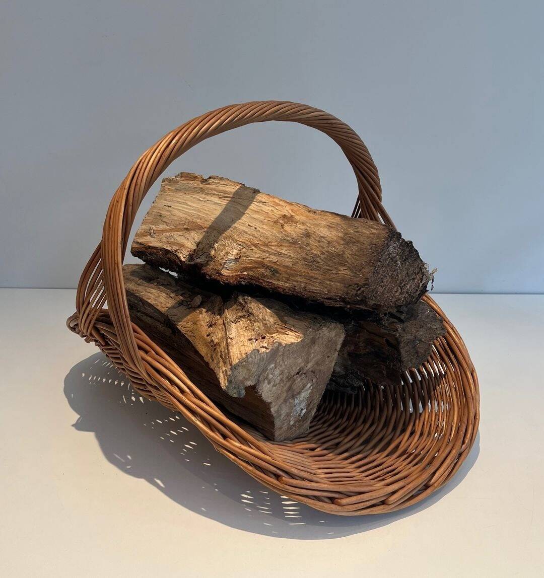 Woven Rattan Log Holder in a Semi-Round Shape with a Central Arched Handle.
