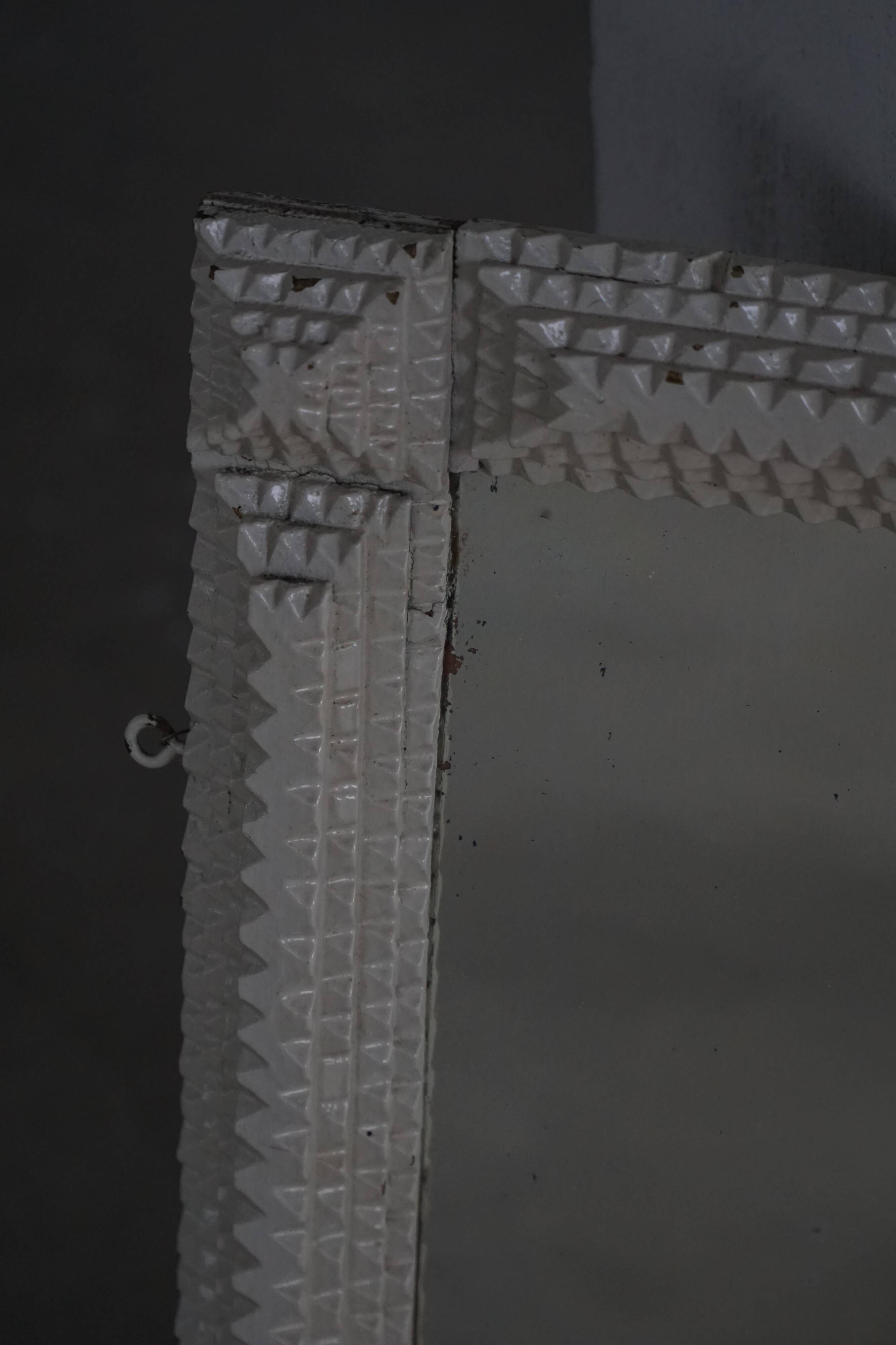 Wall mirror in tramp art style, hand-carved with a painted white frame, early 1900s.