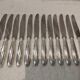 12 silver-plated table knives, Christofle goldsmith ribbons