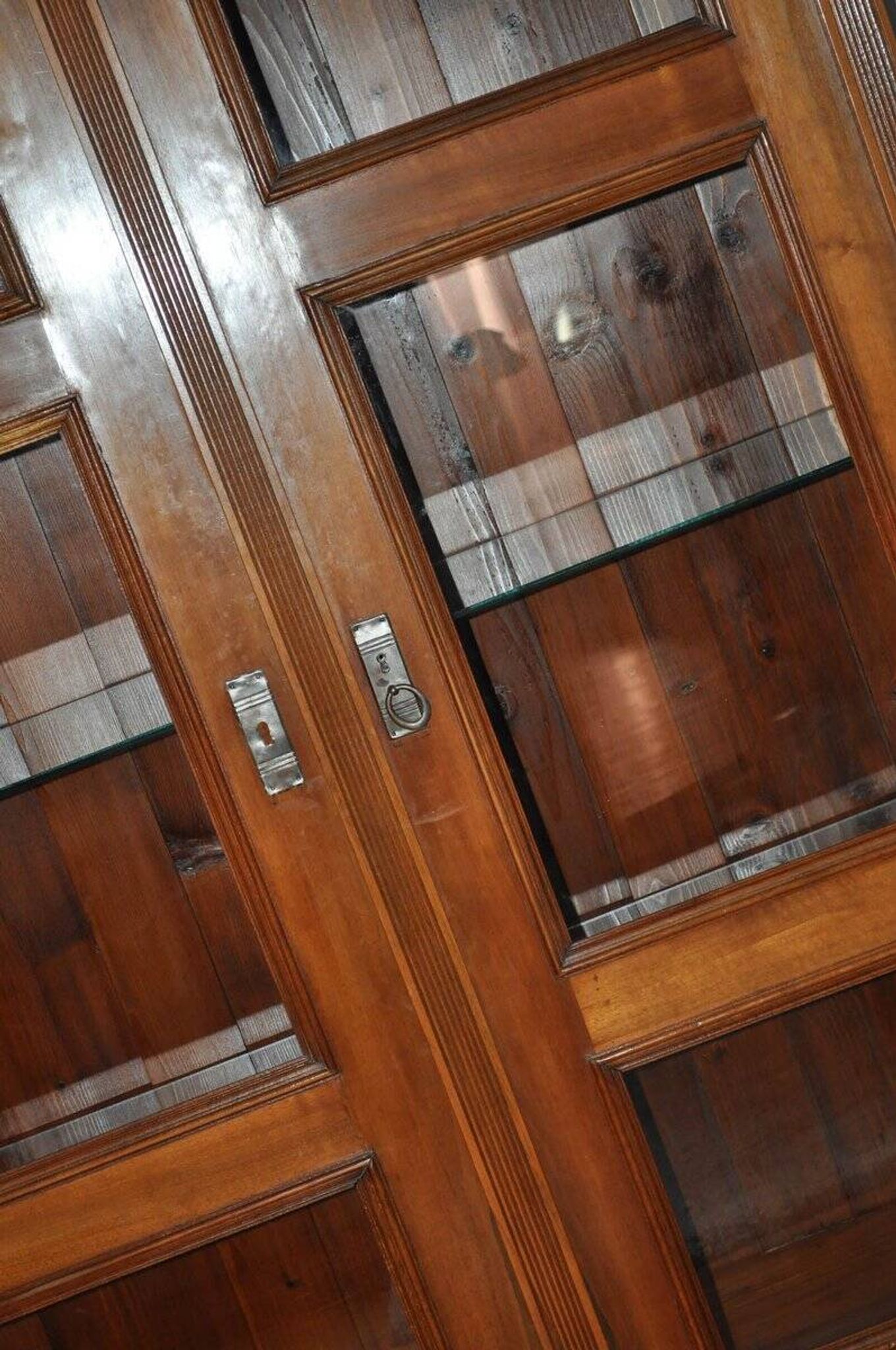 Antique wooden and glass cabinet in brown - 1900 style display case with carved mouldings.