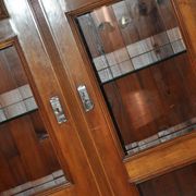 Antique wooden and glass cabinet in brown - 1900 style display case with carved mouldings.