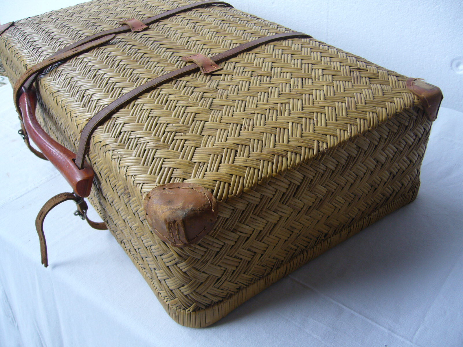 Old rattan case with leather straps and wooden handle