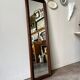 Full-length rectangular mirror in dark wood