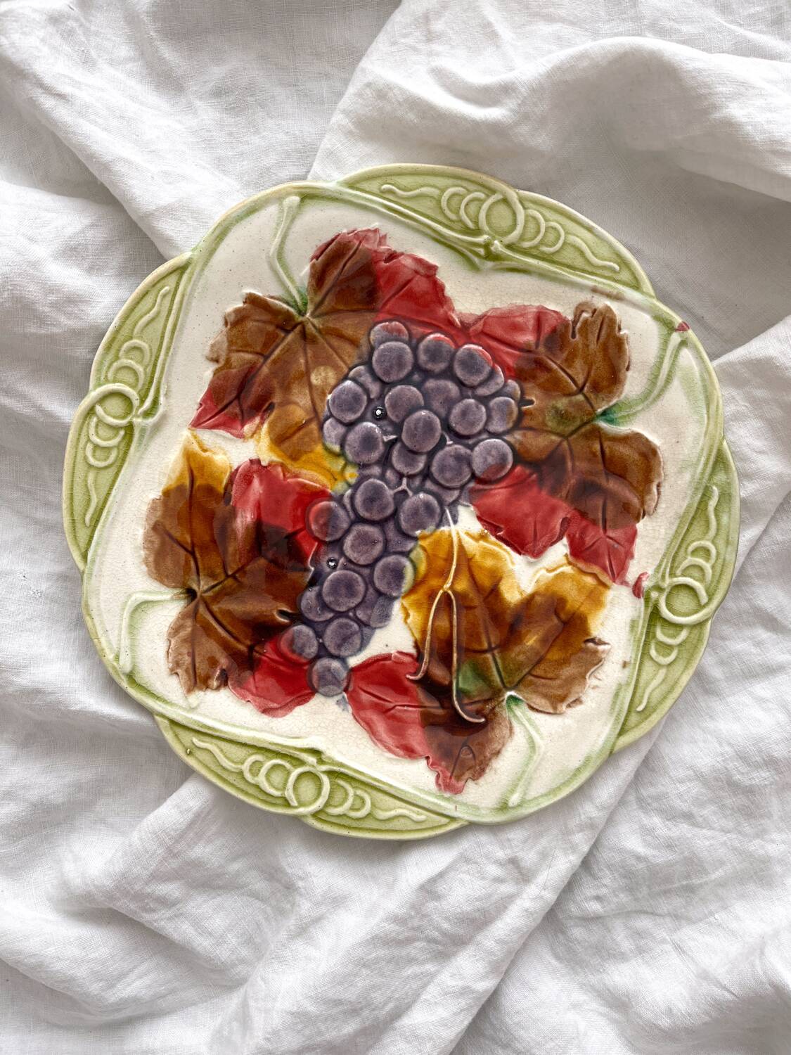 Antique plate in barbotine grapes and vine leaves from Orchies