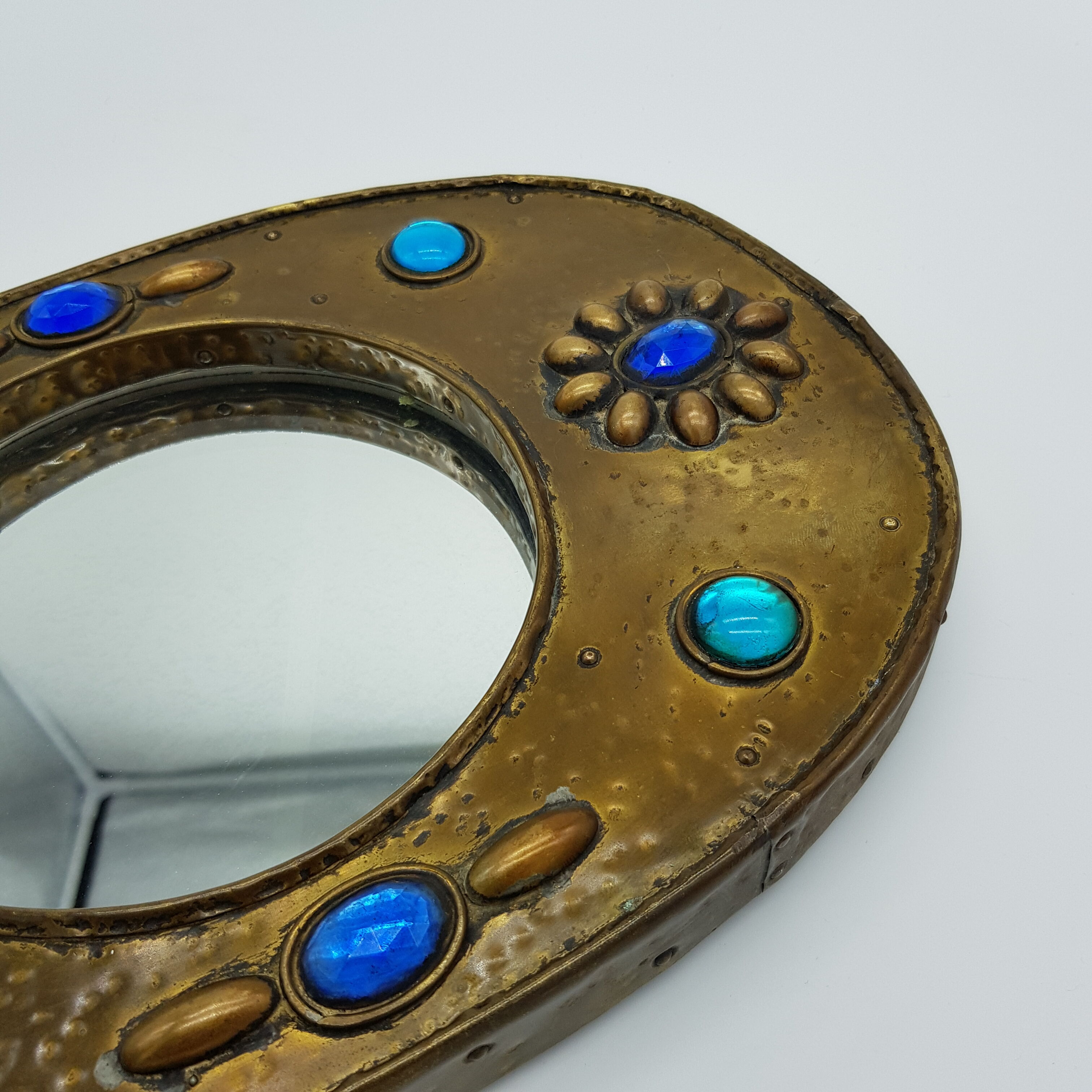 Brass oval mirror and blue cabochons