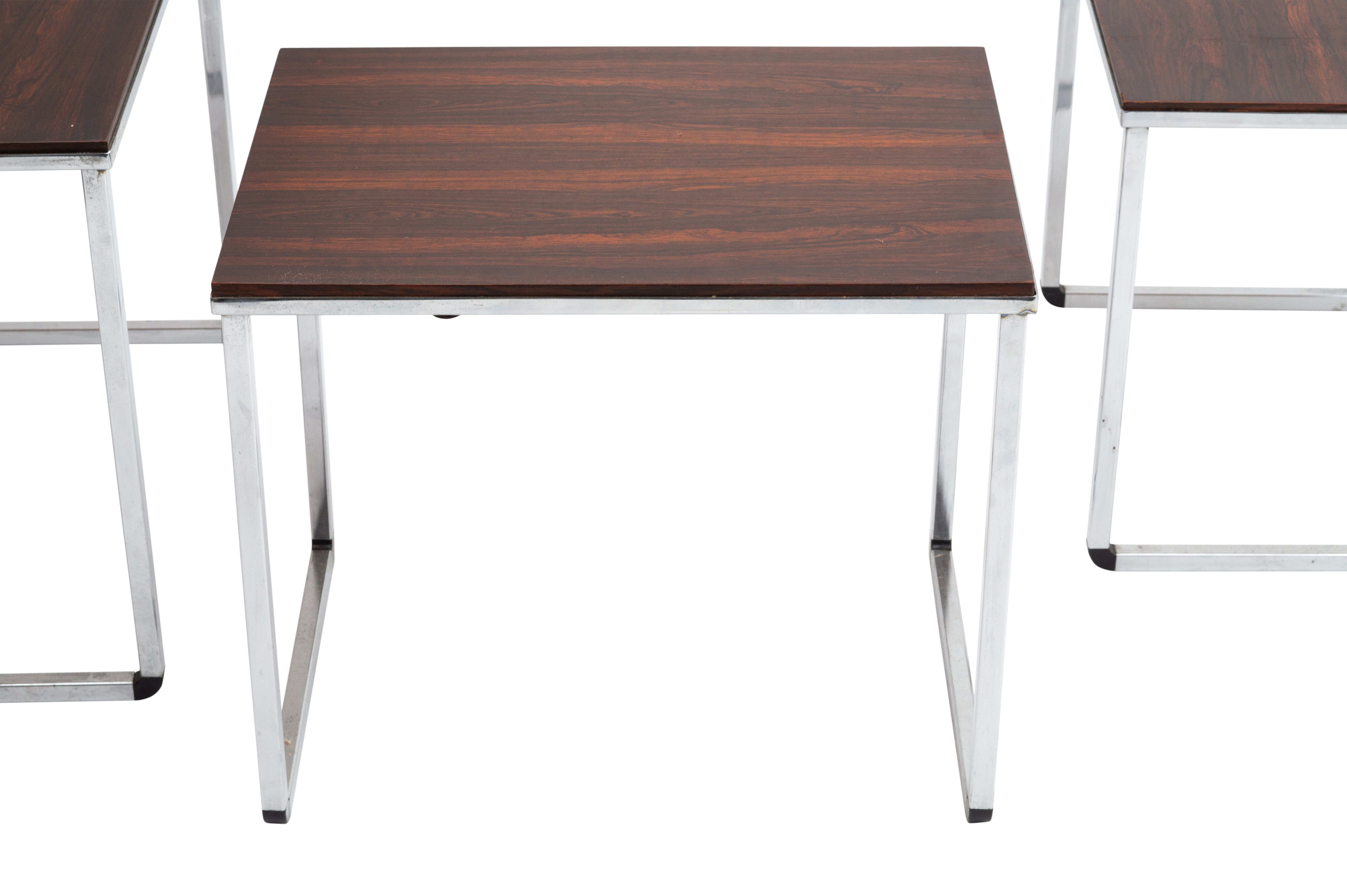 Vintage nesting table in rosewood and high polished metal base.