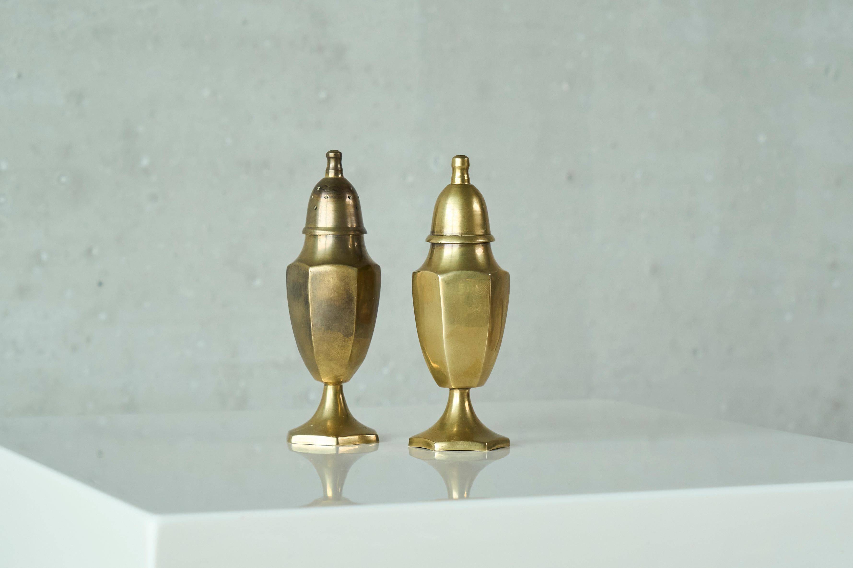 Pair of patinated brass salt and pepper shakers, 20th century.