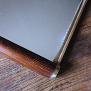 Rectangular mirror tray with wooden handles and gilding.