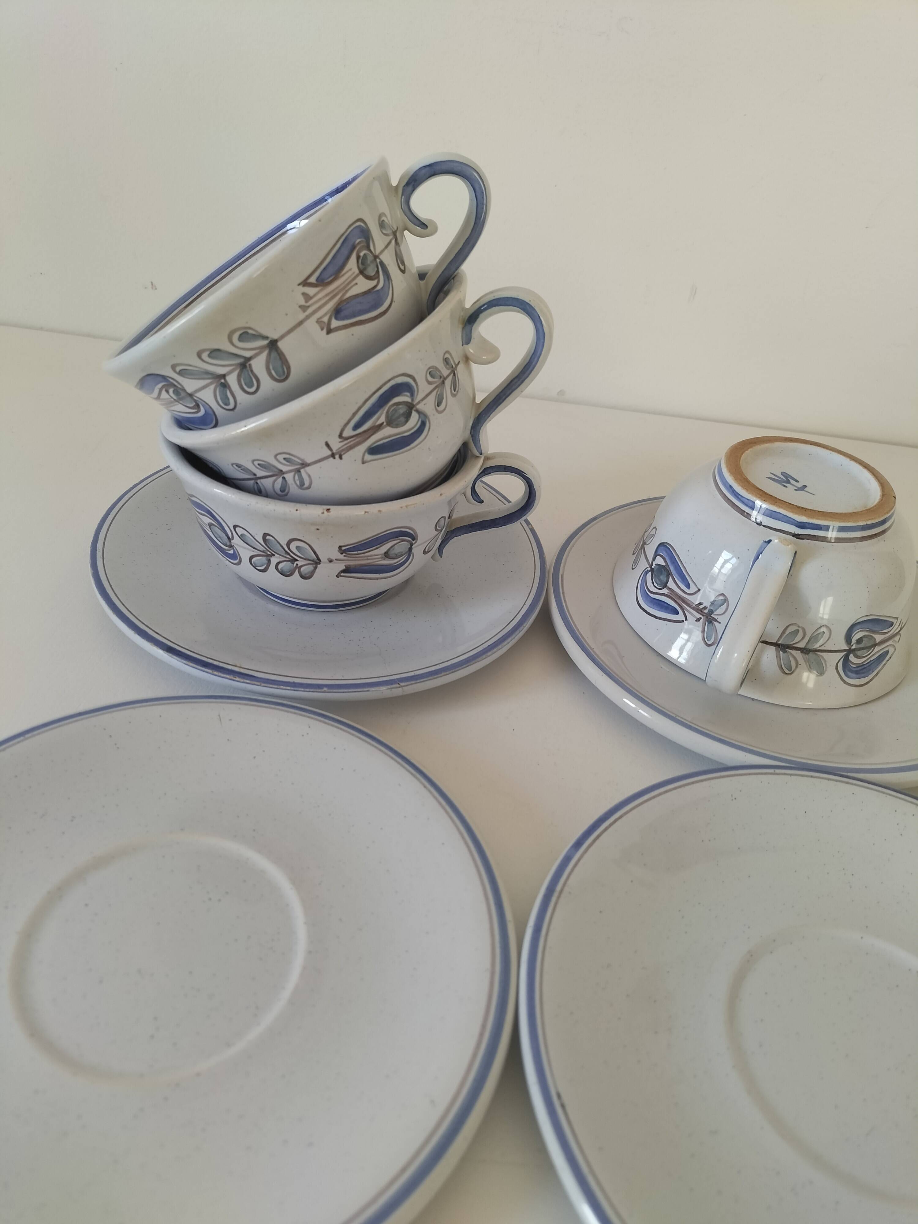 Glazed earthenware cups and saucers