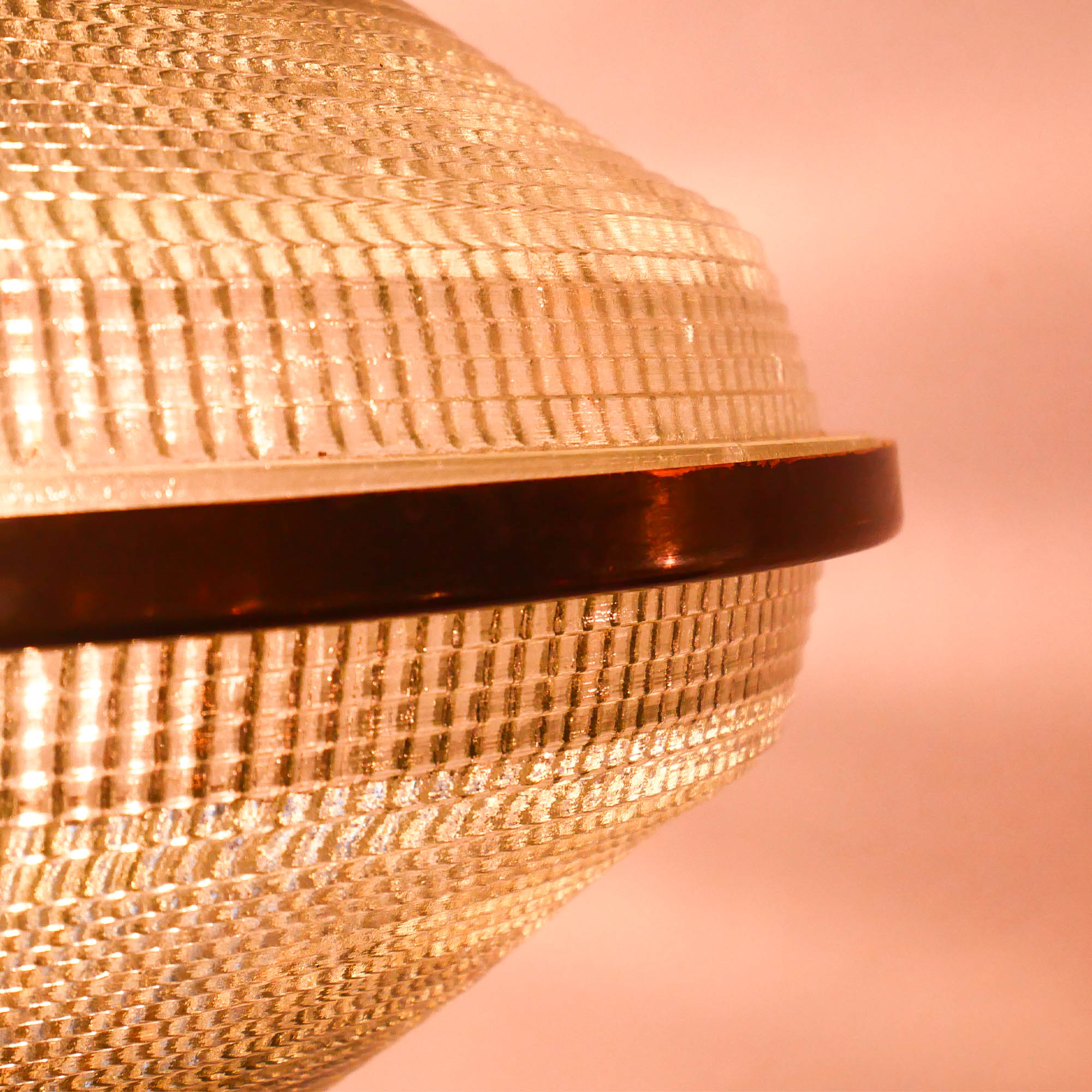 “Ellipse” pendant light in glass and patinated brass.