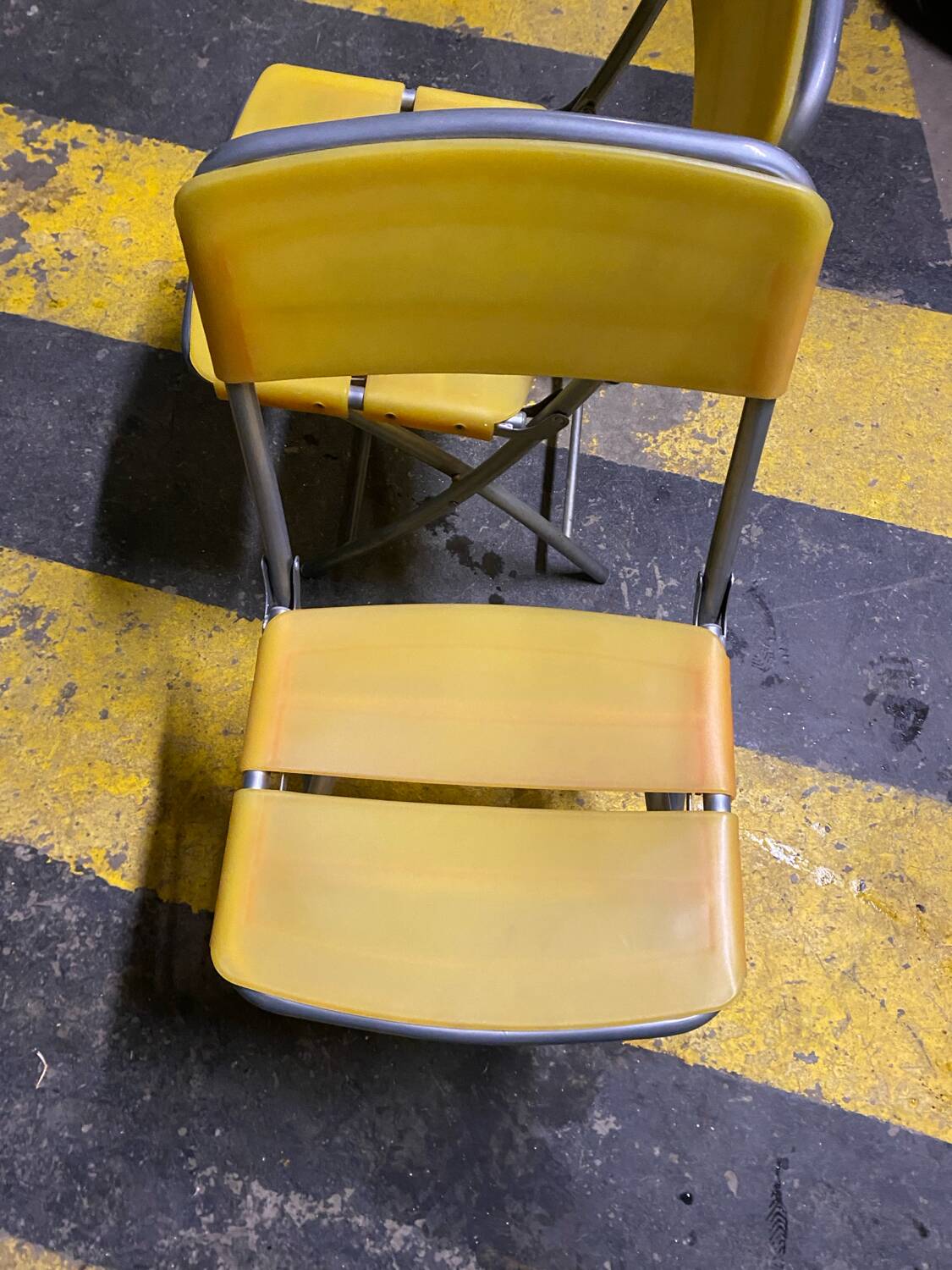 Yellow plastic and steel folding chairs, 1970s