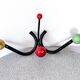 Vintage metal and wood coat rack in yellow/red/green.