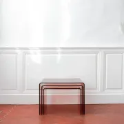 Vintage trio of nesting tables in smoked plexiglass by Michel Dumas, year