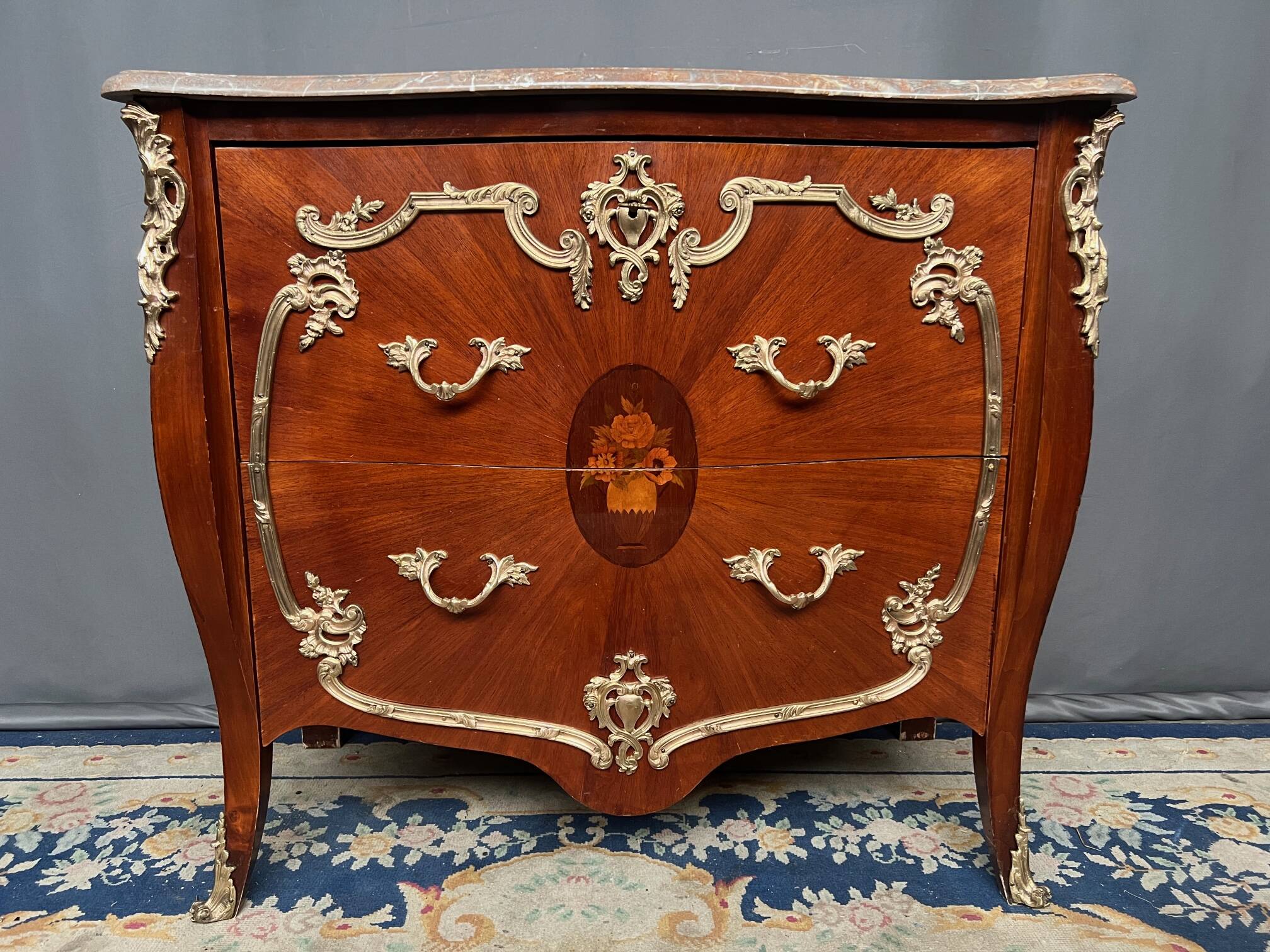 Louis XV style commode. Marquetry, gilded bronze decoration.