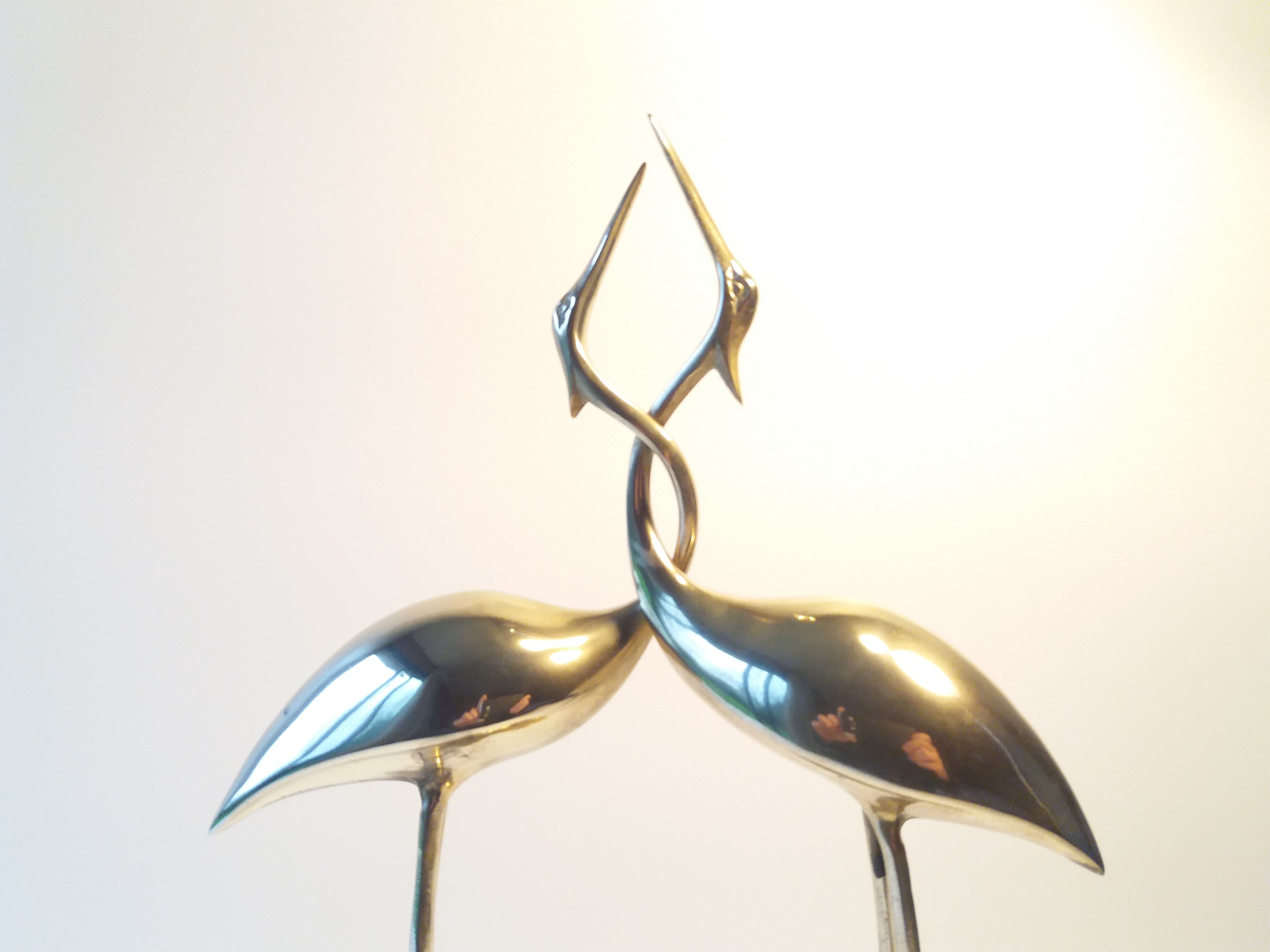 Herons entwined brass