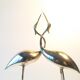Herons entwined brass