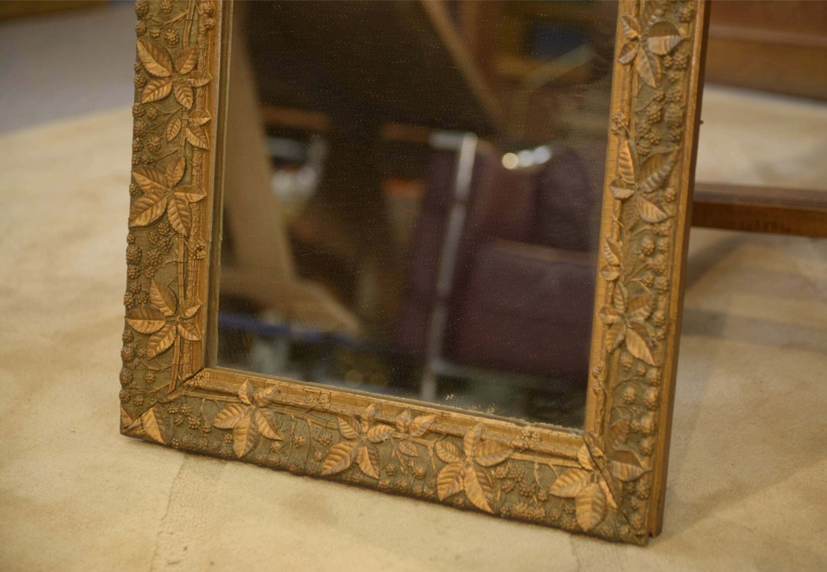 19th-century mirror in wood and stucco with floral decoration.