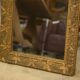 19th-century mirror in wood and stucco with floral decoration.