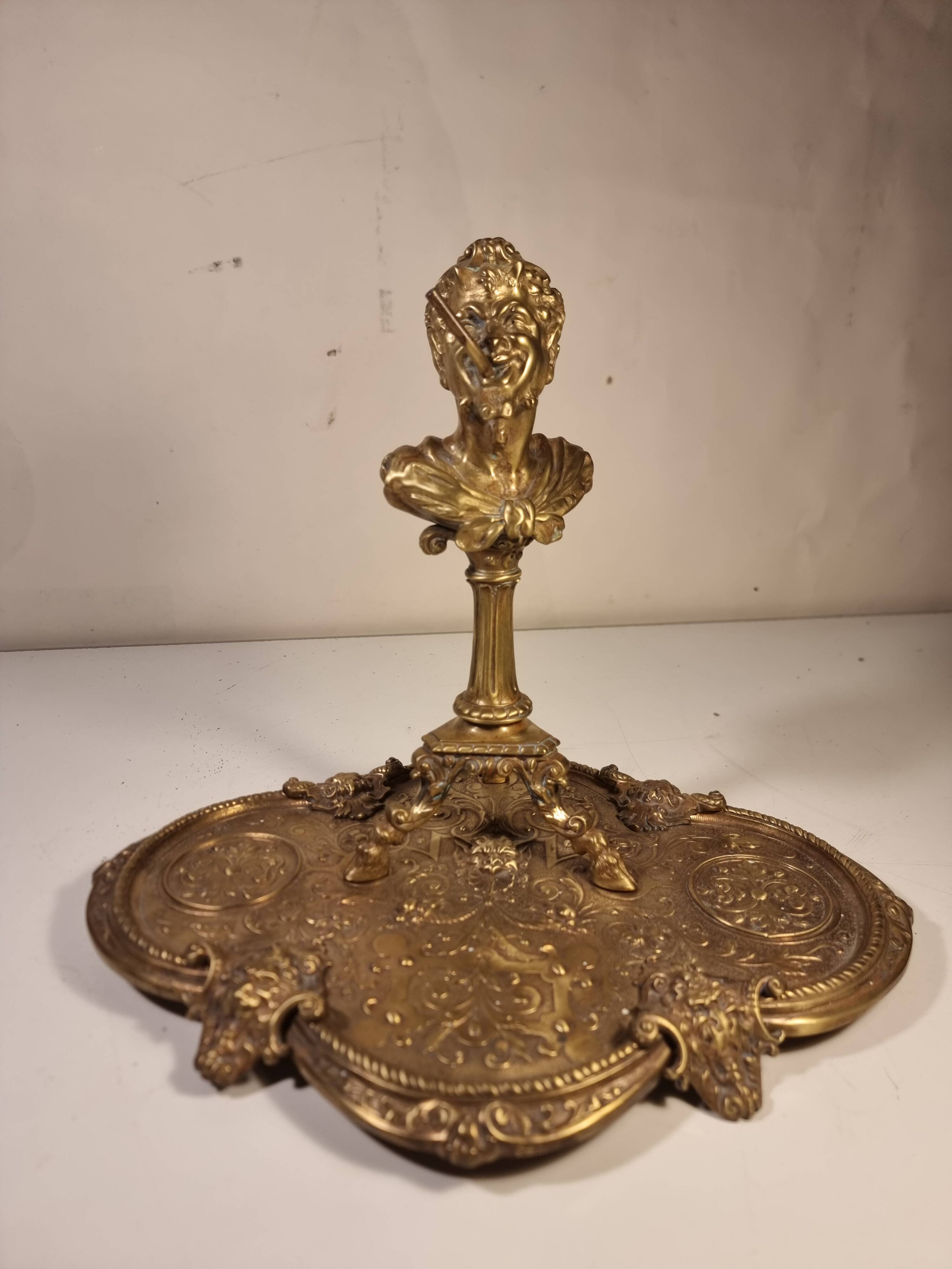 An antique bronze cigar lighter.