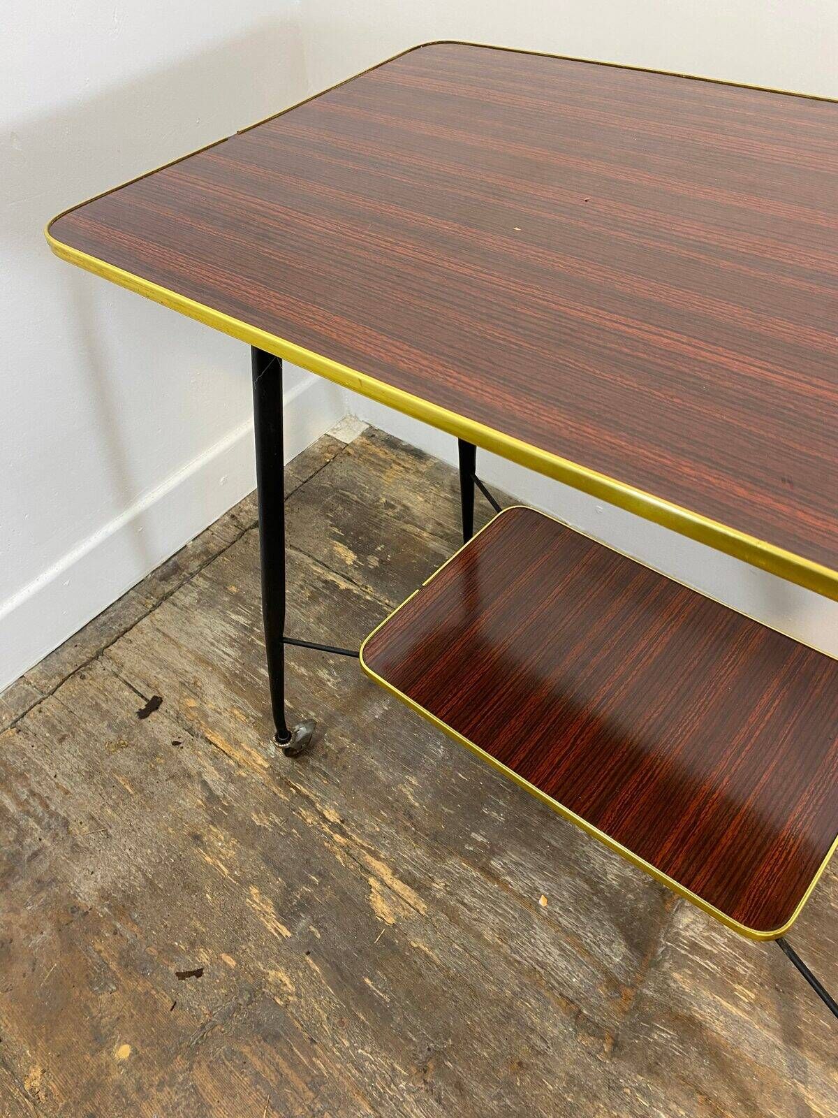 Vintage side table, brass gallery and wheels, 1950s.