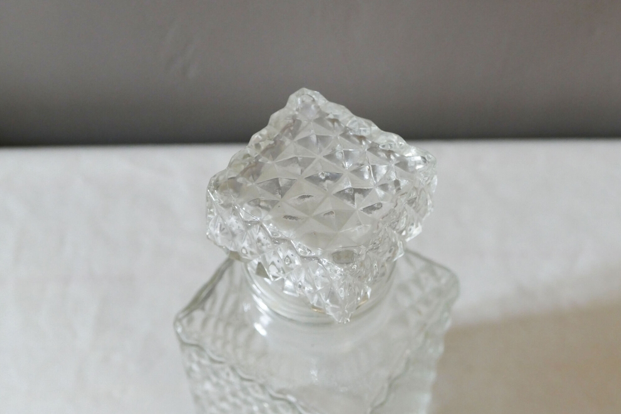 Transparent vintage decanter in chiseled glass and its hermetic cap 70's years