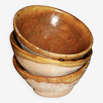 Three rustic terracotta bowls.