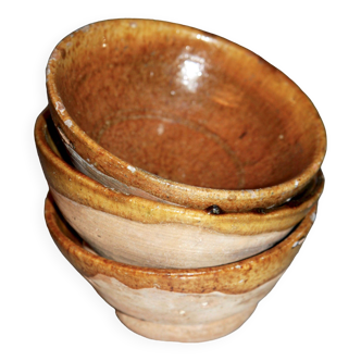 Three rustic terracotta bowls.