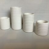 Four white earthenware candle holders