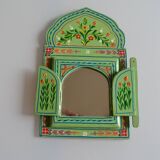 Mirror under shutters with painted flower decoration