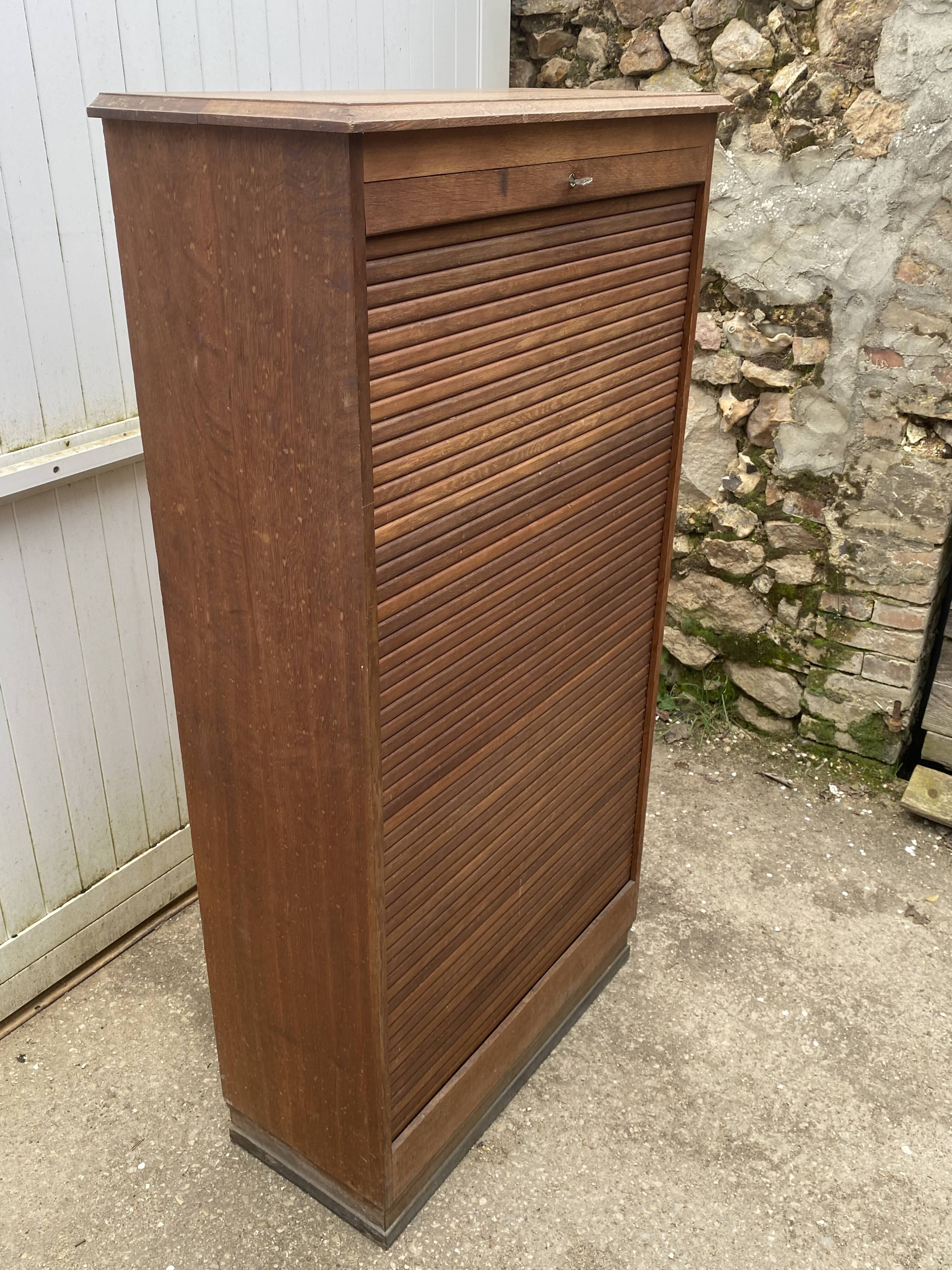 Oak two-column filing cabinet with curtains.