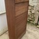 Oak two-column filing cabinet with curtains.