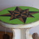 Small wooden stool painted with a star design.