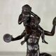Dionysus on the shoulders of a satyr, bronze after the antique on a yellow Siena base.