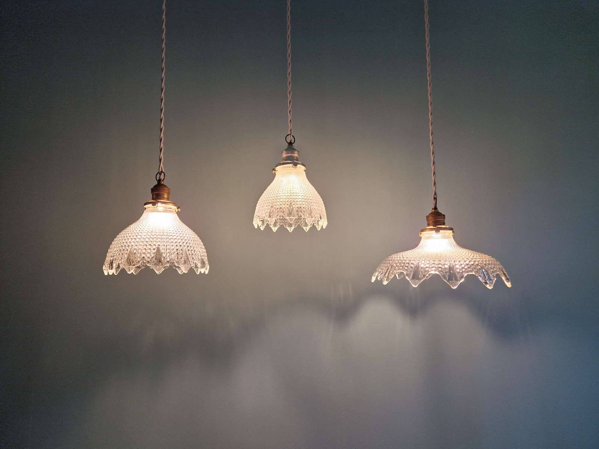 Trio of Art Deco scalloped clear glass pendant lights, 1920-30