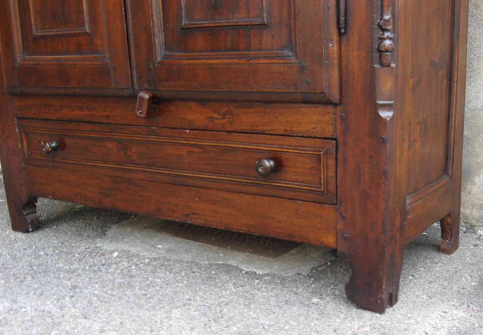 Antique solid wood wardrobe in historical rustic style from the 19th century.
