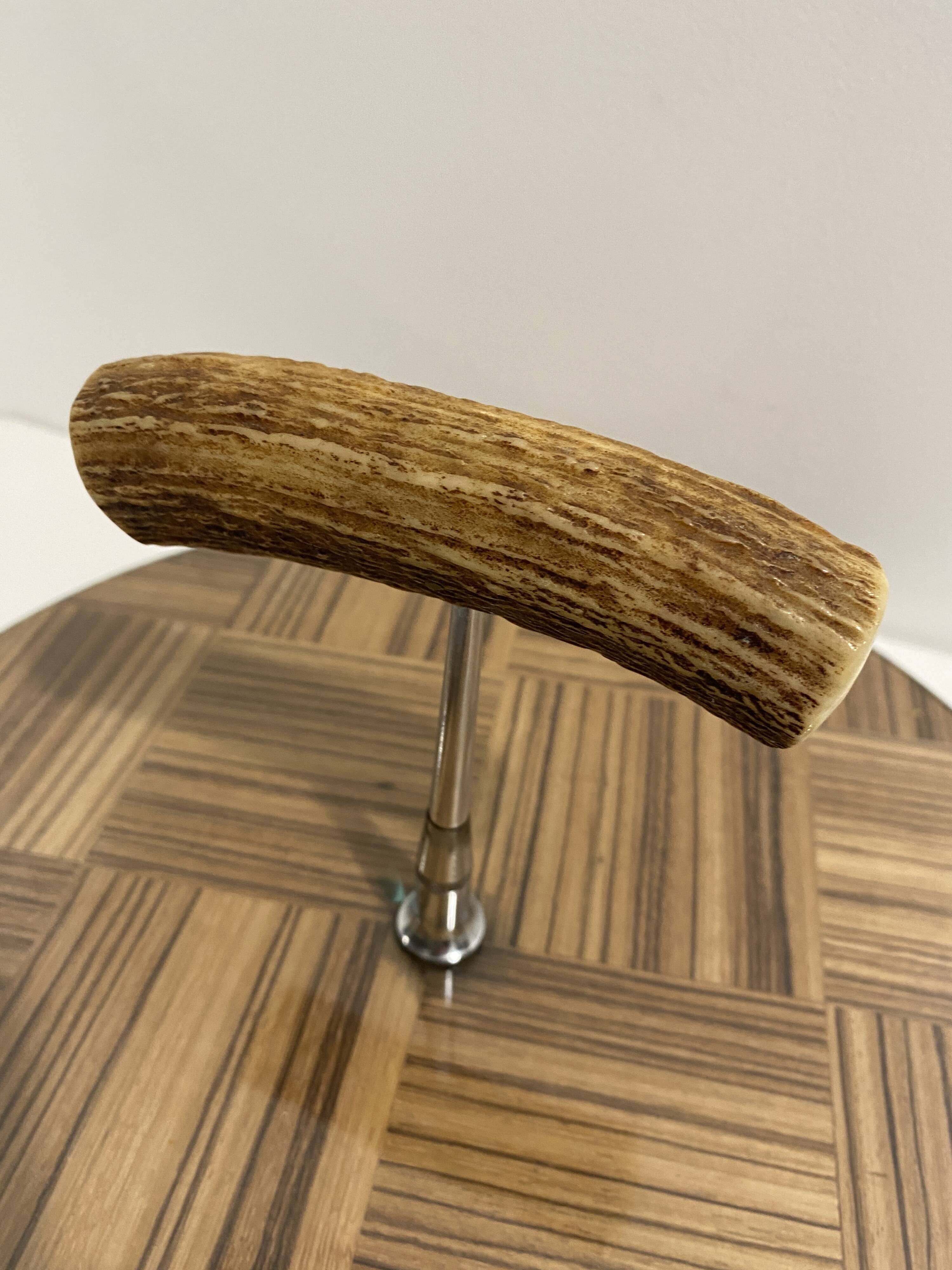 Vintage round wooden cheese board covered with glass plate with foldable handle