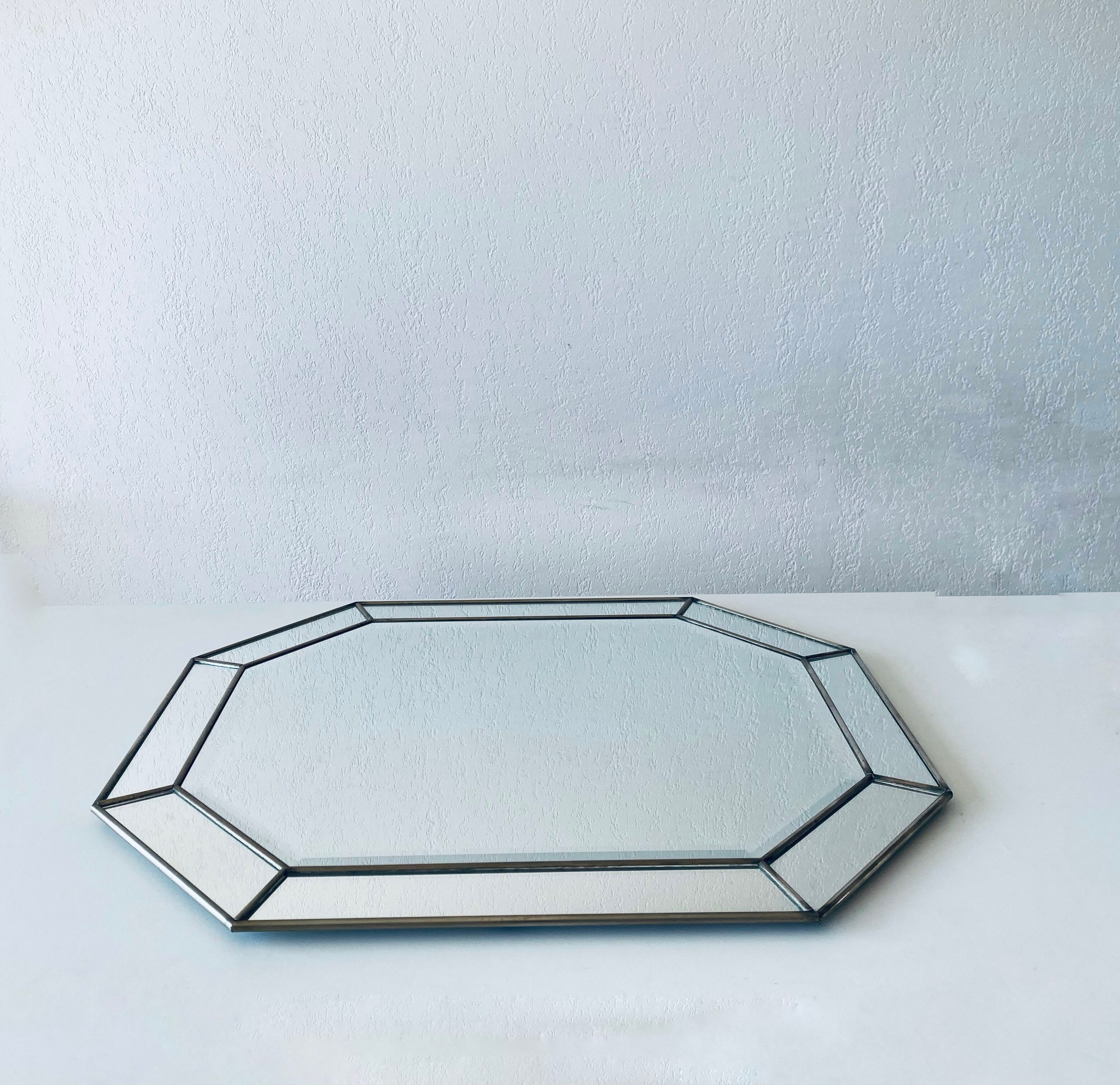 Old octagonal beveled mirror with parcloses