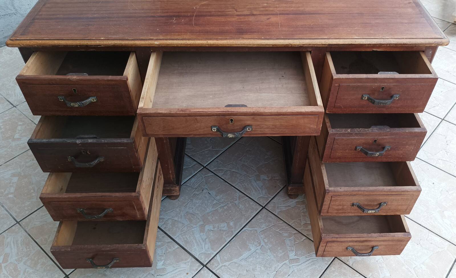Vintage double-sided mahogany desk with 18 drawers.