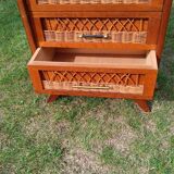 Tall chest of drawers in wood and rattan with splayed legs