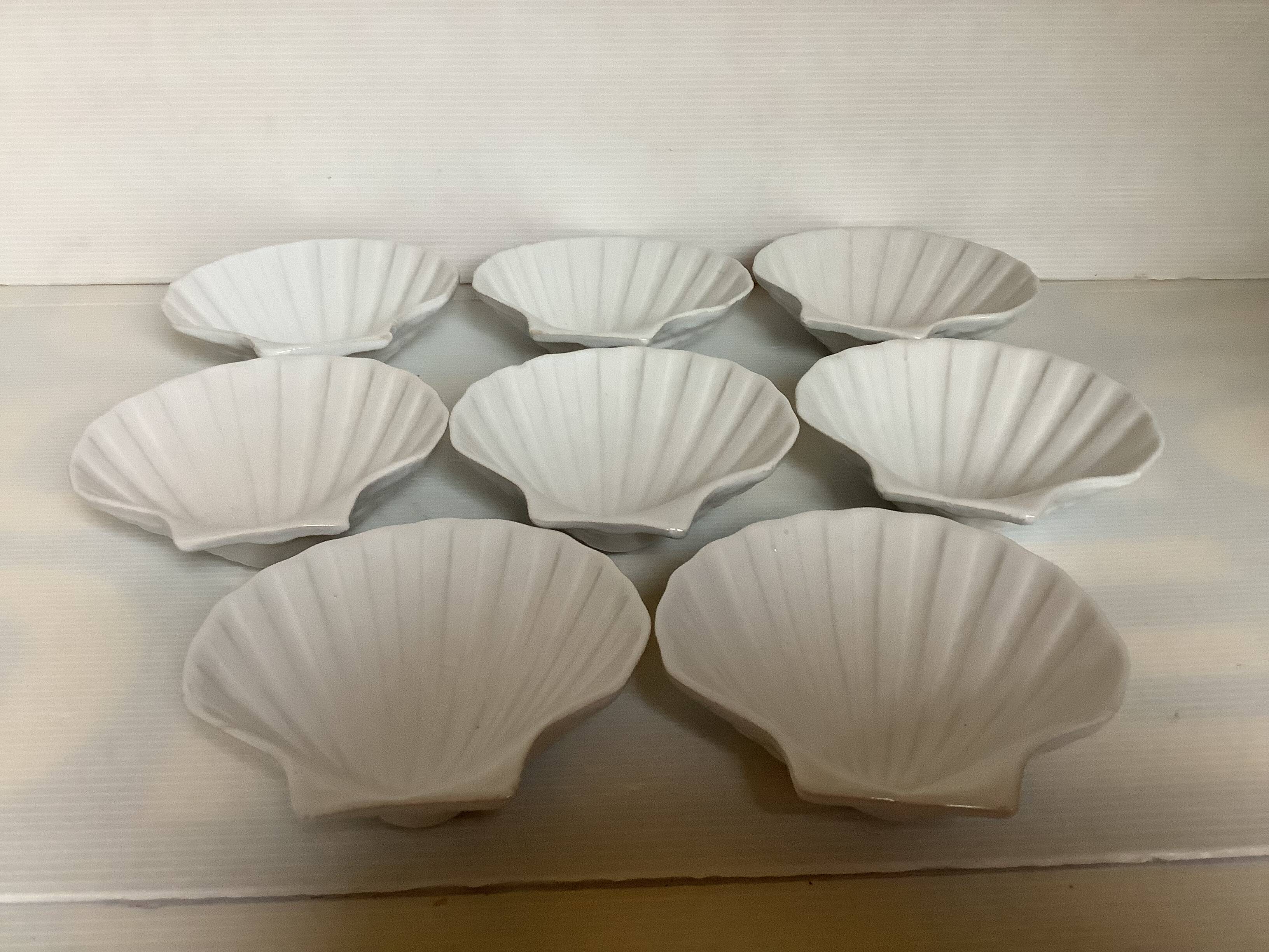 Eight white scallop shell bowls